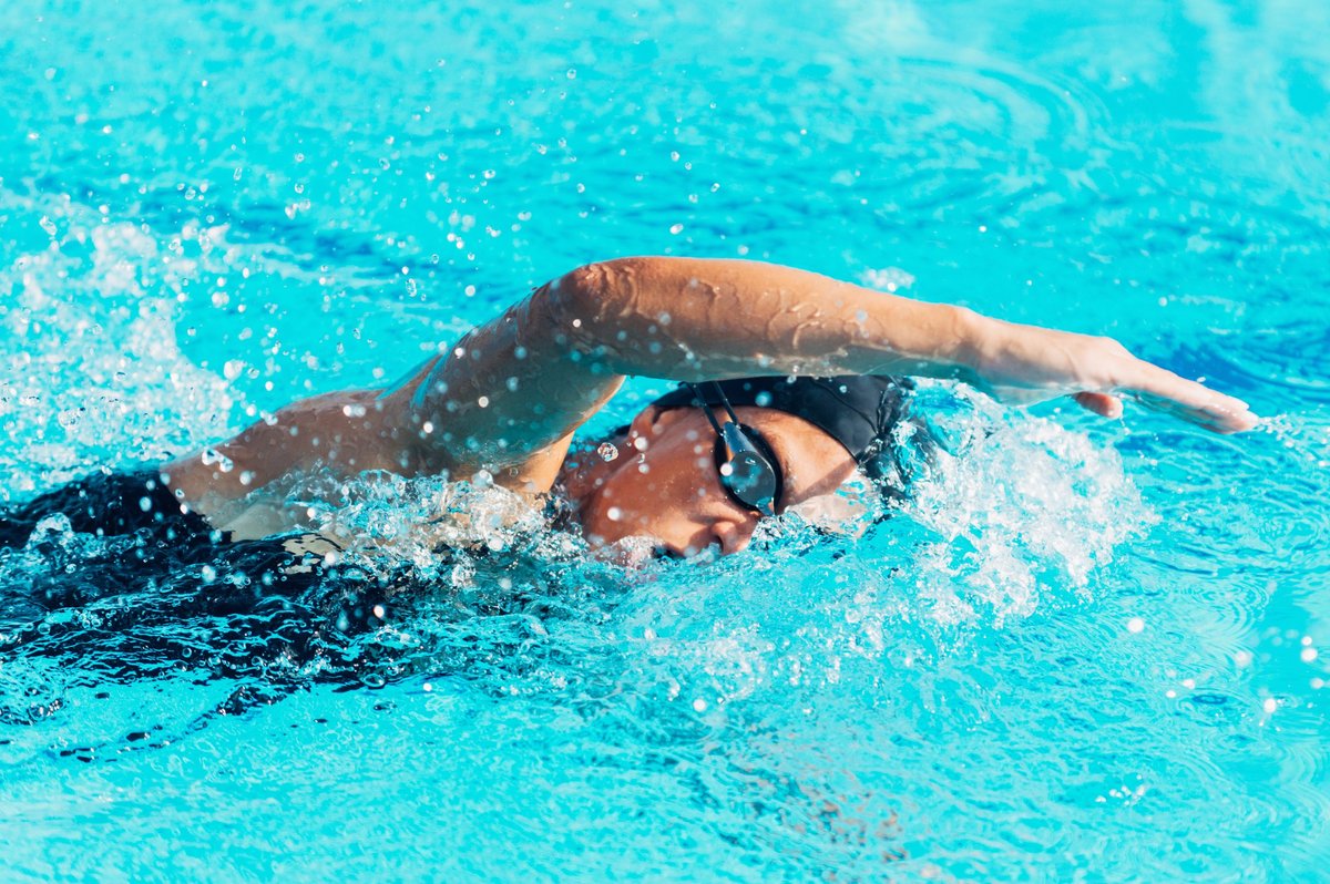 Swimmer. Female swimmer swimming front crawl